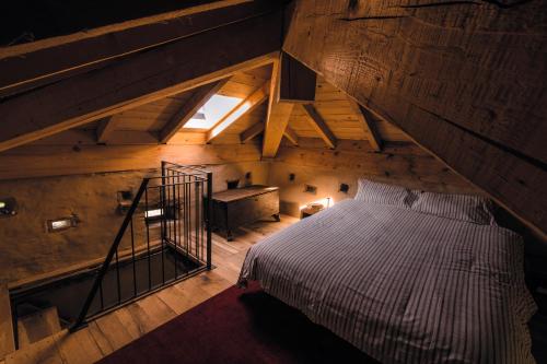 an attic room with a bed and a staircase at Tower house Gombola in Polinago