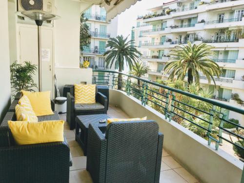 a living room filled with furniture and a balcony at Nice Beach - Promenade Des Anglais in Nice