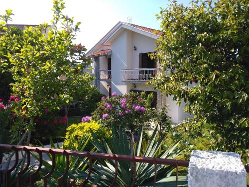 a white building with trees and flowers in front of it at Casa da Piedade, Vouzela in Vouzela