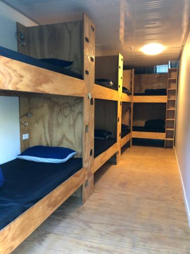 a room with four bunk beds in it at Adventure Inn Marahau in Marahau