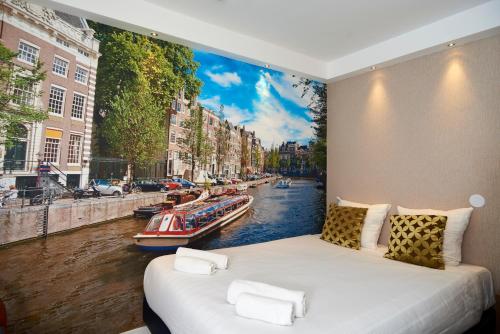 a bedroom with a large painting of a canal at ITC Hotel in Amsterdam