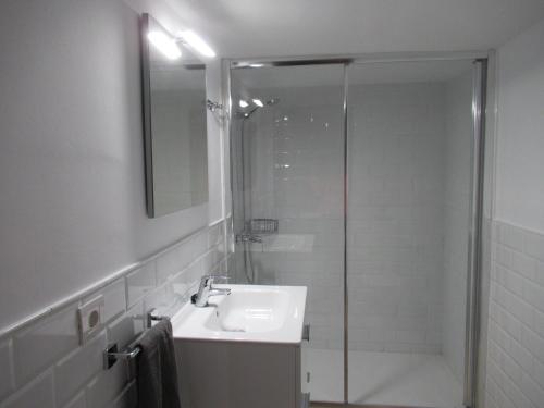 a bathroom with a sink and a glass shower at El Cercado in Tías