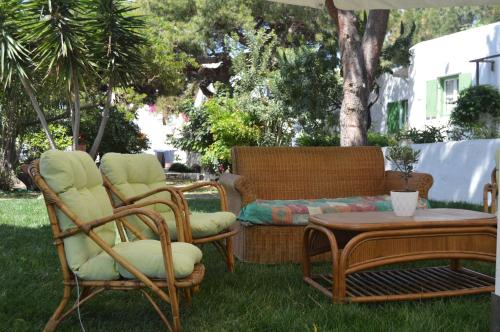 a group of chairs and a couch and a table at Secret Garden Apartments in Mýkonos City
