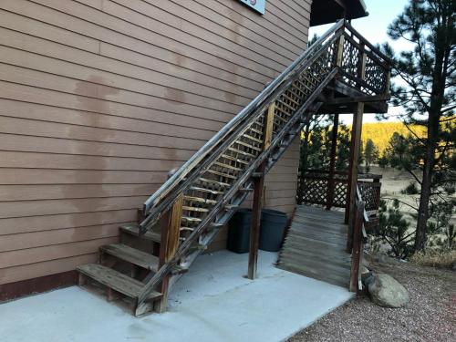 a set of stairs on the side of a house at Black Hills Motel at Quail's Crossing in Hill City