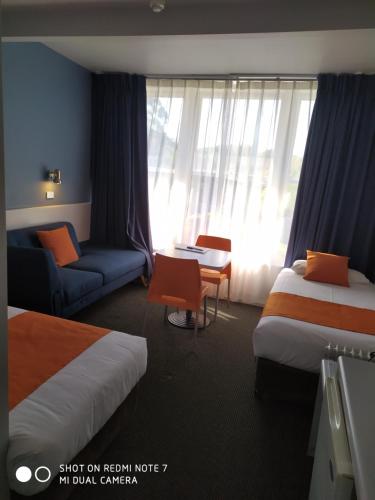 a hotel room with two beds and a couch at Waterfront Lodge Motel in Hobart