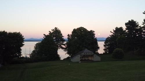 a small white house on a hill near the water at The Inn in Westport in Westport