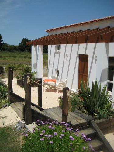 a house with a wooden walkway in front of it at Quinta de Moledos in Aljezur