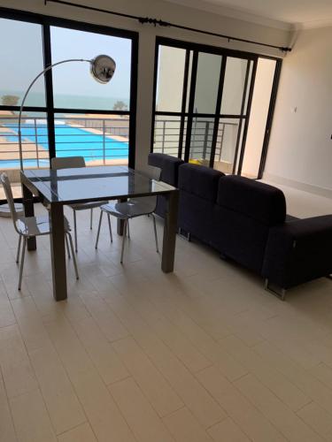 a living room with a couch and a table at WATERFRONT FLAT 2 in Sere Kunda NDing