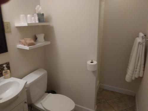 a bathroom with a white toilet and a sink at The Inn in Westport in Westport
