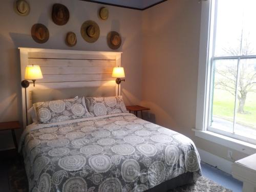 a bedroom with a bed and a window at The Inn in Westport in Westport