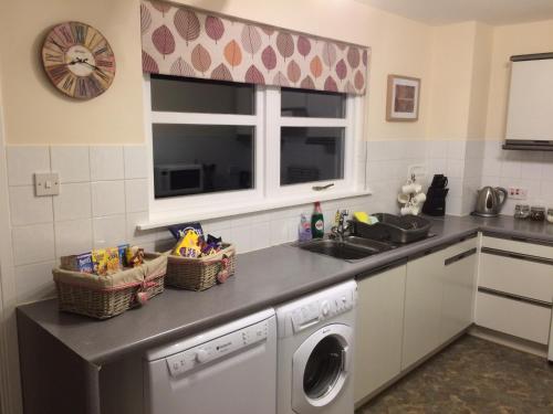 a kitchen with a sink and a washing machine at NUMBER 7 in Kyleakin