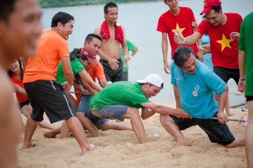 a group of people playing in the sand at Thanh Tu Hotel in Cửa Lò