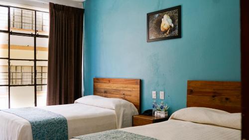 Una cama o camas en una habitación de Acapulco Amor