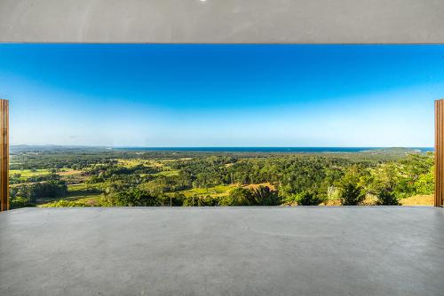 a view of the ocean from the top of a house at Sundays at Byron in Hayters Hill