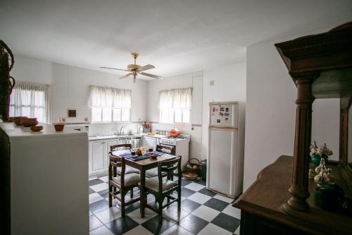 a kitchen with a refrigerator and a table in it at La Providencia in Yerba Buena