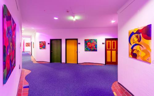 a room with colorful paintings on the walls at artHOTEL Magdeburg in Magdeburg