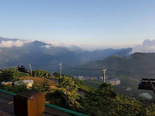 a view of a valley with mountains in the distance at Ming Yang B&B in Fenchihu