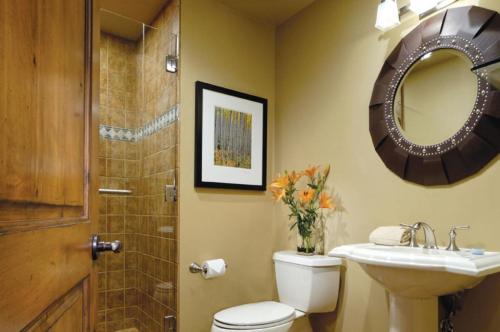 a bathroom with a toilet and a sink and a mirror at Innsbruck Aspen Deluxe One-Bedroom Garden Residence 1, Located on Main Street in Aspen