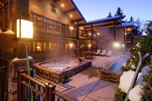 a home with a hot tub in the backyard at Innsbruck Aspen Deluxe One-Bedroom Garden Residence 1, Located on Main Street in Aspen