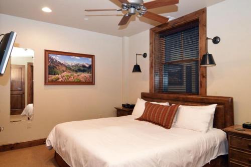 a bedroom with a bed and a ceiling fan at Innsbruck Aspen Deluxe One-Bedroom Garden Residence 1, Located on Main Street in Aspen