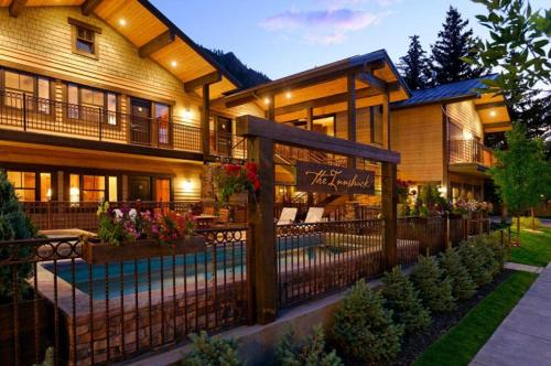 a large house with a fence in front of it at Innsbruck Aspen, Deluxe One-Bedroom Junior Suite 01 w/ Hot tub, Centrally located in Aspen