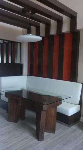 a living room with a white couch and a table at Avida San Lazaro 1 BEDROOM with balcony near SM San Lazaro in Manila