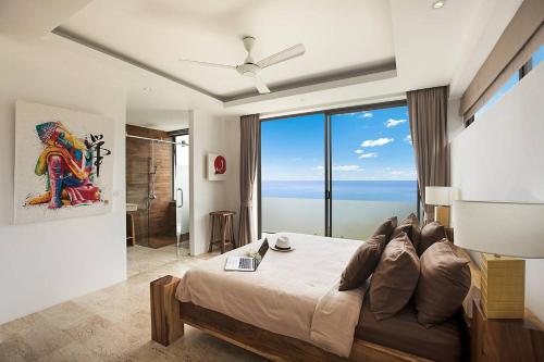 Un dormitorio con una cama grande y una ventana grande. en Luxury SeaView Villa -Double Infinity Pools-20 Persons, en Chaweng