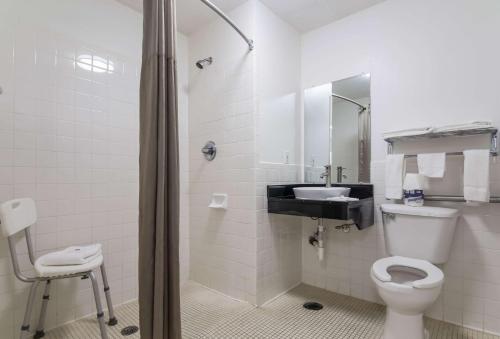 a bathroom with a toilet and a sink at Motel 6-Gulf Shores, AL in Gulf Shores