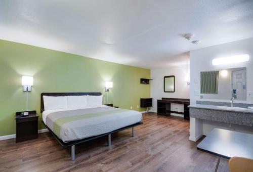 a hotel room with a bed and a sink at Motel 6-Burlington, WA in Burlington