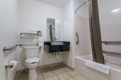 a bathroom with a toilet and a sink and a shower at Motel 6-Gulf Shores, AL in Gulf Shores