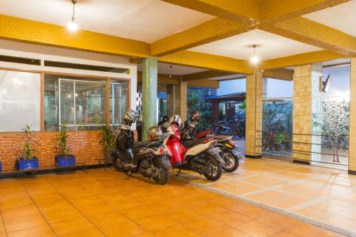 a group of motorcycles parked in a garage at RedDoorz Plus @ Surapati 2 in Bandung