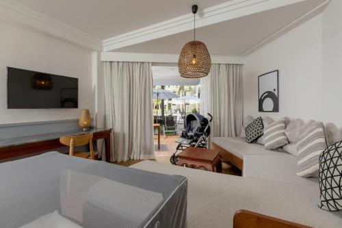 a living room with a couch and a table at Sunwing Bangtao Beach in Bang Tao Beach