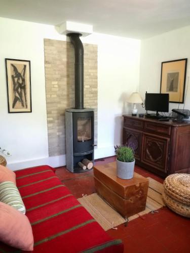 a living room with a fireplace and a couch at Gîte d'Aigues Vives in Céré-la-Ronde