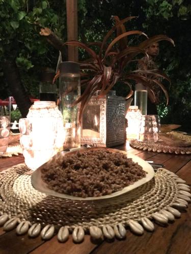 a table with a plate with a potted plant on it at Samura Maldives Guest House Thulusdhoo in Thulusdhoo