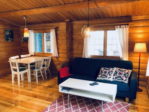 a living room with a blue couch and a table at Vasa Ski Lodge in Mora