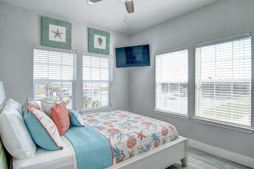 a bedroom with a bed and two windows at Pathway 14838 in Padre Island