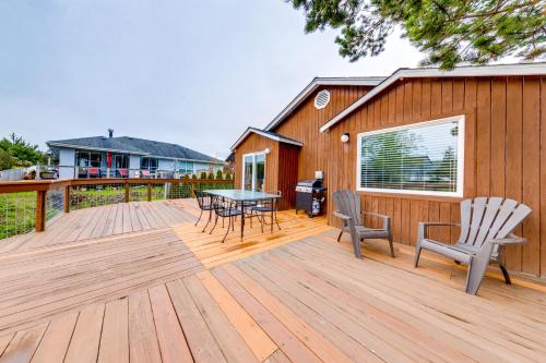 a wooden deck with a table and chairs on it at 2 Bed 1 Bath Vacation home in Seaside in Seaside