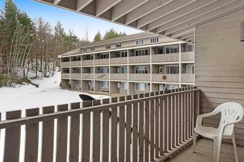a balcony with a white chair and a building at 1 Bed 1 Bath Vacation home in Newry in Newry