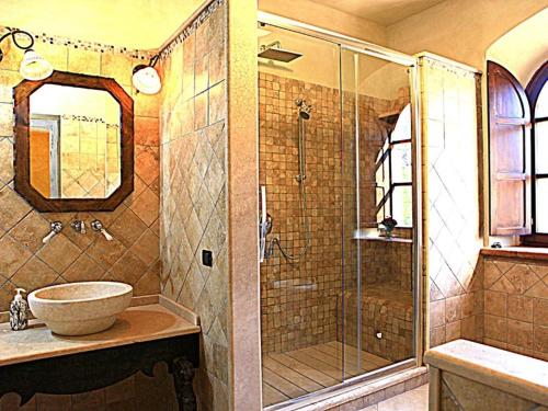 a bathroom with a sink and a glass shower at I Segreti del Borgo in Penna in Teverina