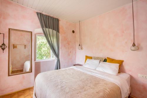 a bedroom with a large bed and a mirror at Central, Quiet & Romantic Apartment in Herceg-Novi