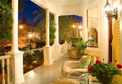 a porch with chairs and a view of a city at Azalea Inn and Villas in Savannah