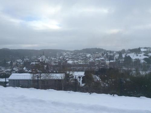 a city covered in snow with buildings in the background at Ferienwohnung Höhenweg 25 in Nettersheim
