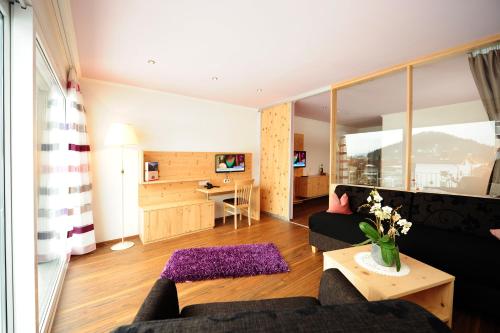 a living room with a couch and a table at Hotel Gasthof Zum Schwanen in Reutte