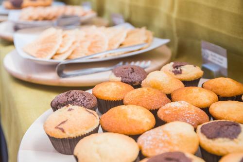 a display of muffins and other pastries on a table at Hotel Prestige in Montesilvano