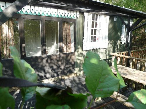 a screened in porch of a house with a window at Romany Wagon & Cwtch in Llandysul
