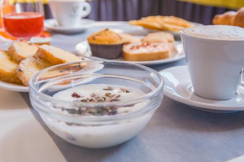a table topped with plates of food and a cup of coffee at Hotel Prestige in Montesilvano