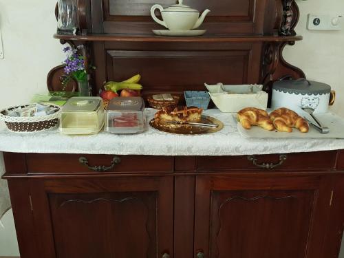 a counter with bread and other foods on it at Hotel Sant'Agostino in Paola