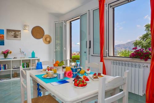 a dining room with a table with food on it at Villa Delfino - Scopello-Villas in Scopello