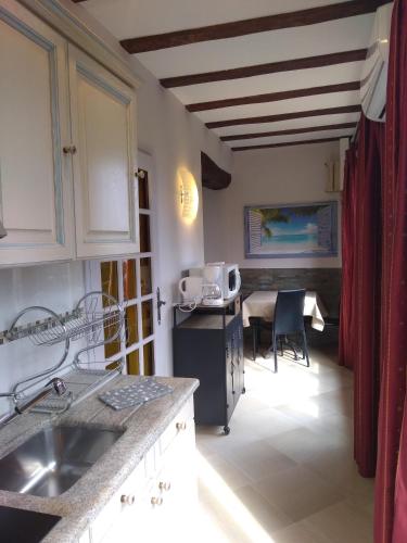 a kitchen with a sink and a table with a microwave at Villa Azur Cap d'Ail in Cap d'Ail