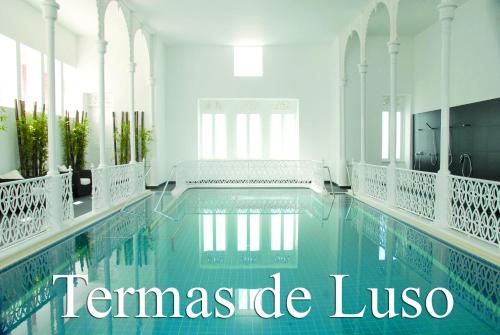 a swimming pool with the words temperate lusico at Alegre - Bussaco Boutique Hotel in Luso